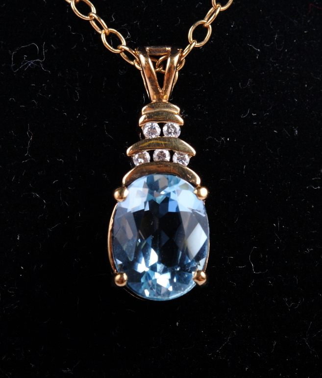 A 9ct gold, diamond and aquamarine pendant on chain and a rolled gold pendant on chain set synthetic