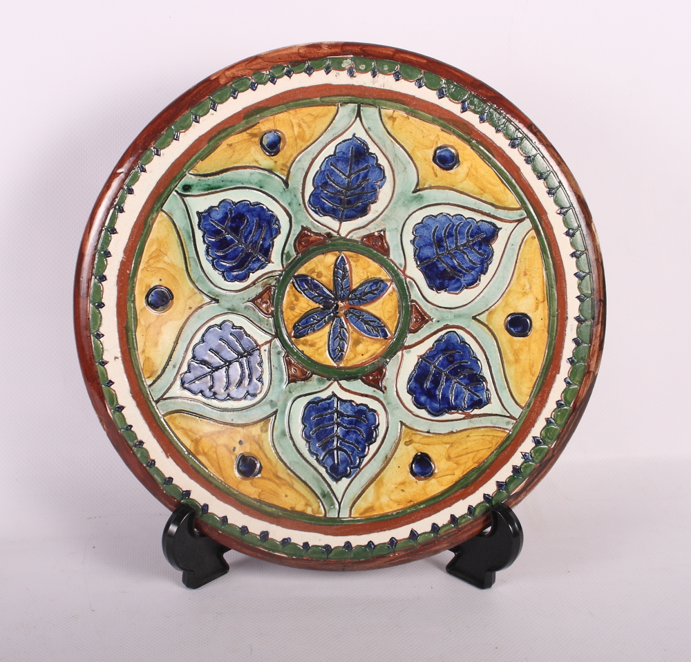 A Carlo Manzoni, Minerva Art ware (ex Della Robbia Birkenhead) Arts & Crafts charger, 10 1/4" dia