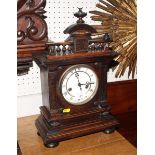 A 19th Century walnut cased mantel clock with eight-day striking movement, 16" high