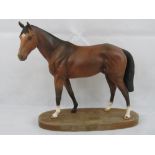 A large Beswick figurine of a racehorse 'Troy', on wooden plinth, 30cm wide.