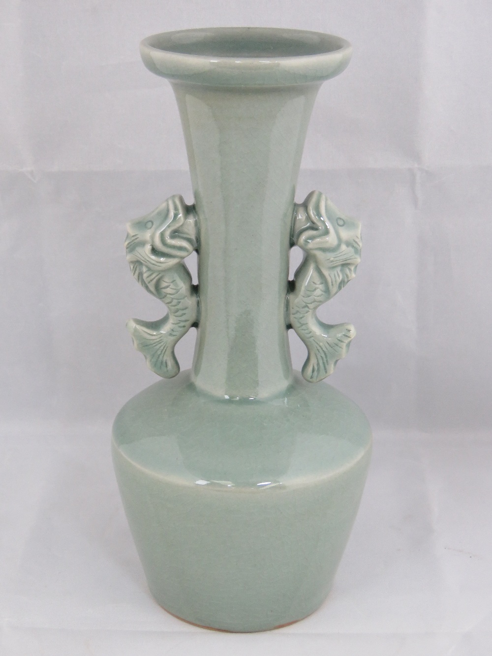 A reproduction celadon glaze vase with twin fish handles, 24cm high.