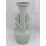 A reproduction celadon glaze vase with twin fish handles, 24cm high.