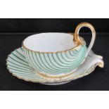 A late 19th century continental nautilus shell shaped tea cup and saucer,