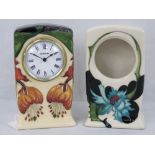 A Moorcroft Anna Lily clock (16cm high) together with a Moorcroft Sea Holly clock case (16cm high).