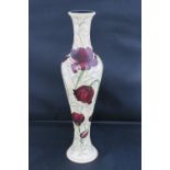 A Moorcroft tall slender vase with purple flowers, 32cm high.