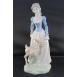 A Tengra porcelain figurine of a young lady with a fawn; 31cm high. .