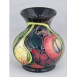 A Moorcroft vase with Queen's choice design, 10cm high.