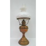 A late Victorian brass oil lamp with shade and replacement glass chimney; overall height 55cm.