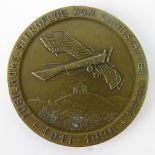 A German Pilot's medallion "1911-1936" with Nazi swastika to reverse; 6cm diameter.