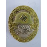 A good reproduction WW2 Nazi Wounded badge dated 20th July 1944; white metal with gilt decoration;