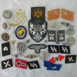 Over 20 reproduction WW2 Nazi badges and collar tabs.