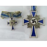 A Nazi Mother's Cross medal (4cm long) together with a miniature cross; both with ribbons.