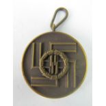 A Nazi SS 8 year service medal in bronzed brass; 3.5cm diameter.