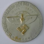 A reproduction Nazi "NSFK 1938" white metal plaque; 8cm diameter.