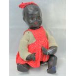 A 20th century black doll by Plastex, moulded head, sleepy eyes and open mouth, jointed limbs.