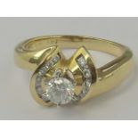 A 14k gold and diamond ring, central rou