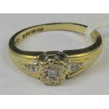 A 9ct gold and diamond ring. Central ill