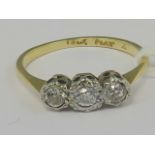 An 18ct gold three stone diamond ring, d