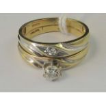 A pair of 10ct gold rings joined togethe