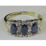 A 14ct gold sapphire and diamond ring. T