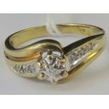 A 9ct gold and diamond ring. Central ill