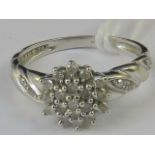 A 9ct white gold diamond cluster ring, c