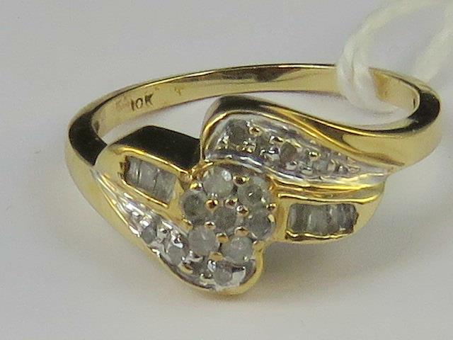 A 10ct gold and diamond ring. Three rows