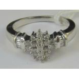 A 9ct white gold and diamond ring, centr