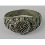 A white metal ring with Swastika surroun
