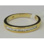 A 9ct gold and diamond ring, nine channe