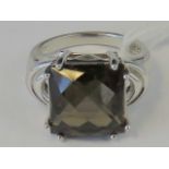 A silver and smoky quartz ring, central