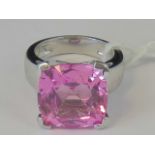 A silver ring set with large square pink