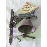 An exterior cast metal bell with sailboa