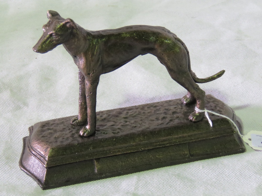 A cast metal greyhound figurine on base,