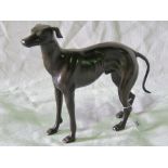 A cast bronze effect standing greyhound