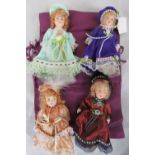 Four contemporary miniature dolls in tra