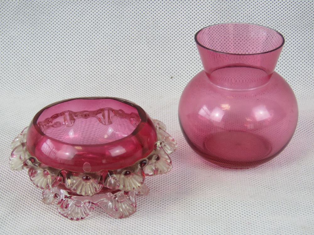 Two cranberry glass bowls.