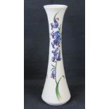 A Moorcroft tall slender vase with blueb