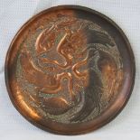 An Art Nouveau copper tray decorated wit