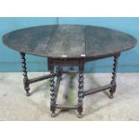 A c1930s oval drop leaf table raised ove