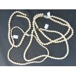 Three faux pearl necklaces; a triple strand a/f and two single strand.