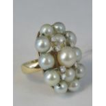 A 14ct gold pearl and diamond cocktail ring, thirteen pearls and seven diamonds approx 0.