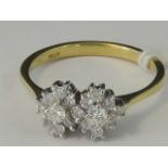 An 18ct gold diamond double cluster ring, hallmarked 750, 2.89g. Size L-M.