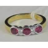 An 18ct gold diamond and ruby five stone ring, three round rubies approx 0.