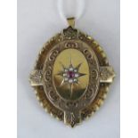 A yellow metal memorial pendant,