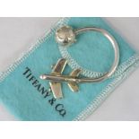 A key fob with airplane and globe terminals stamped 925 Tiffany, with box and pouch.