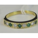 An 18ct gold emerald and diamond half eternity ring,