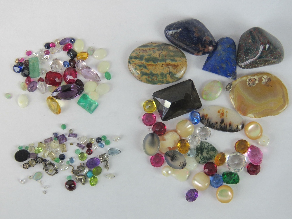 A quantity of loose semi precious and paste stones including rubies, sapphires etc.