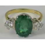 A superb 18ct gold emerald and diamond ring. Huge central oval emerald approx 4.