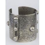 A heavy white metal cuff bangle with Arabic hallmarks.